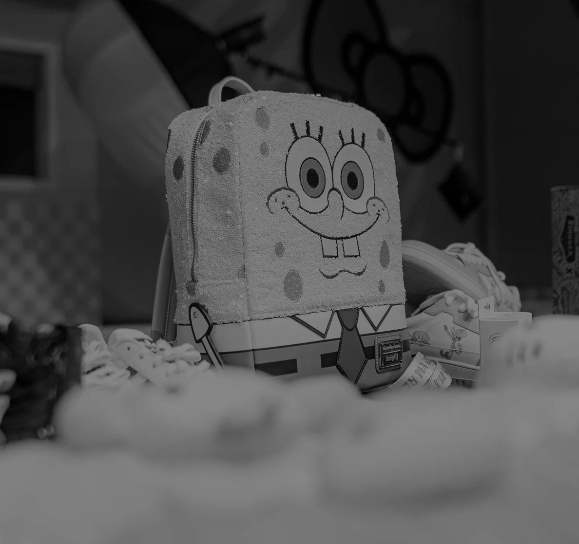 SpongeBob SquarePants plush toy on a bed with a blurred background